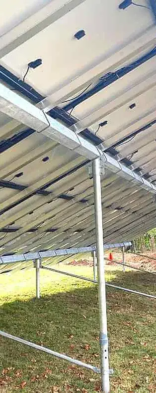 underside of ground mounted solar panel system installed in connecticut with galvanized steel framing and optimized cable management
