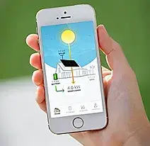 Hand holding smartphone displaying real-time solar energy production with Premier Improvements Solar monitoring app in East Hartford Connecticut.